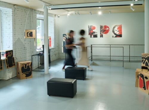 Visitors walking along gallery hall